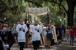 The Blessed Sacrament is carried beneath a canopy during a Eucharistic procession through Forsyth Park in Savannah, Georgia, May 27, 2026.
