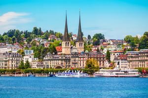 The twin spires of the Church of St. Leodegar, known as the Hofkirche, rise above the lakefront in Lucerne, Switzerland. 
