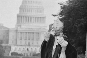  Pope John Paul II, with the U.S. Capitol in the background, blesses the crowd gathered at the National Mall, where he celebrated Mass, on Oct. 7, 1979. Leaving the U.S. after his tour, the Pope said, “My final prayer is this: that God will bless America so that she may increasingly become, and truly be and long remain, ‘One nation, under God, indivisible with liberty and justice for all.’ God bless America.” 
