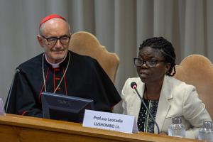 Catholic theologian Léocadie Lushombo speaks during the presentation of Pope Leo’s first encyclical on May 25, 2026, at the Vatican as Cardinal Michael Czerny listens.