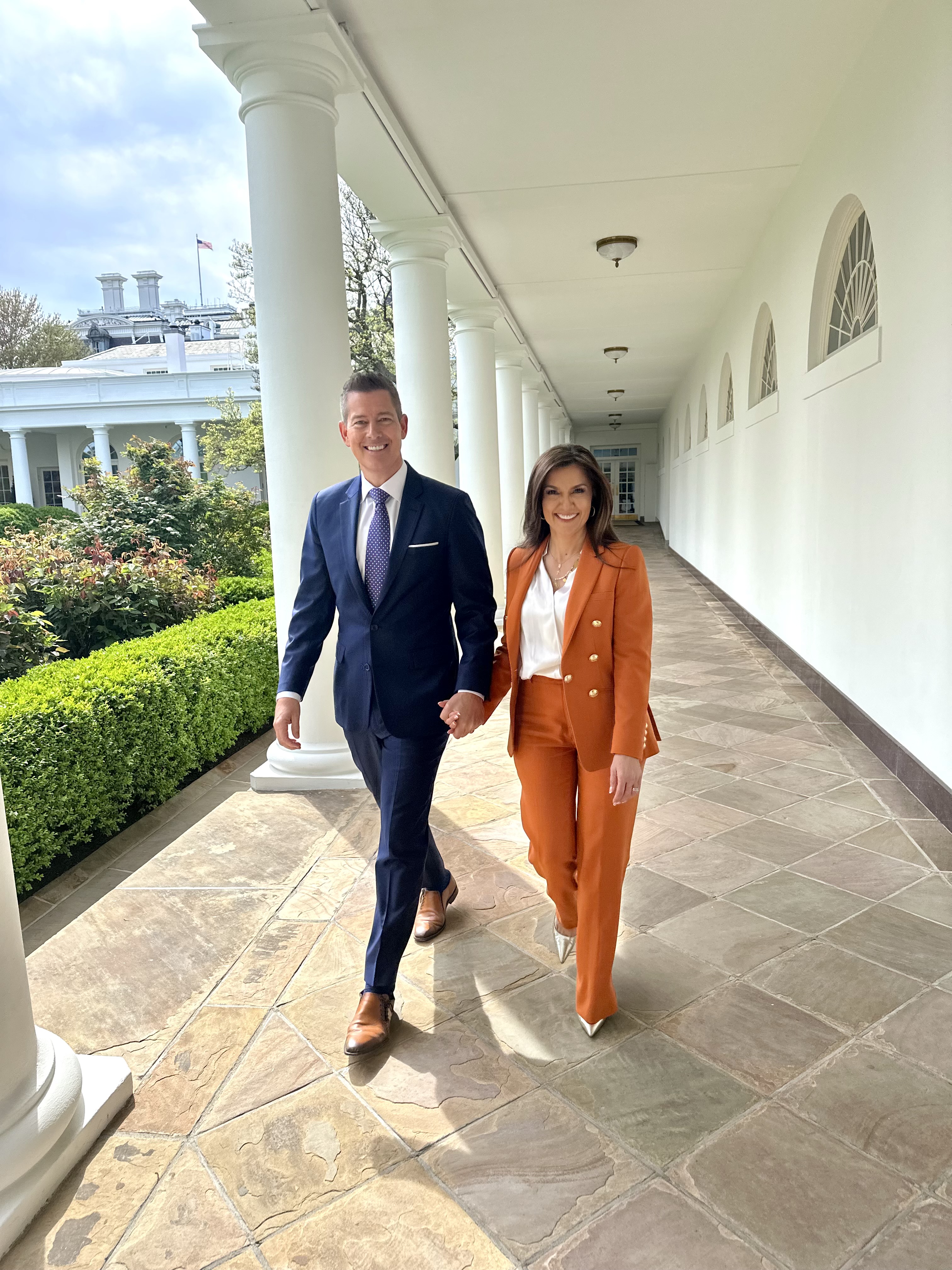 Secretary of Transportation Sean Duffy walks with his wife Rachel Campos-Duffy of Fox News alnog the grounds of the White House.