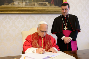 Pope Leo XIV signs his first encyclical, "Magnifica Humanitas," on May 15, 2026, in the apostolic palace at the Vatican, in the presence of Archbishop Paolo Rudelli, substitute for general affairs of the Secretariat of State. 
