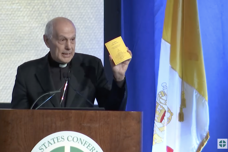 Archbishop Gabriele Caccia addresses the U.S. Conference of Catholic Bishops in Orlando, Florida, on June 10, 2026, and presents a pocket-sized volume containing Lumen Gentium and Dei Verbum, the Second Vatican Council’s dogmatic constitutions.