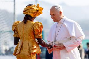 Pope Leo XIV greets Bousso Diouf, a woman from Senegal, at the Las Raíces reception center in Spain’s Canary Islands.