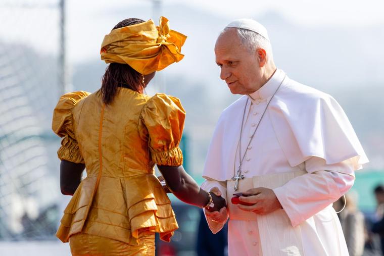 Pope Leo XIV greets Bousso Diouf, a woman from Senegal, at the Las Raíces reception center in Spain’s Canary Islands.