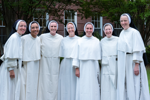 Sister Mara Grace Gore (center), the vocations director of the Dominican Sisters of St. Cecilia in Nashville, smiles alongside her fellow sisters. 