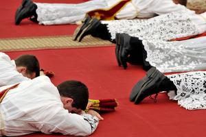 New priests prostrate themselves during the ordination Mass of the Society of St. Pius X in Écône, Switzerland, on June 29, 2009.