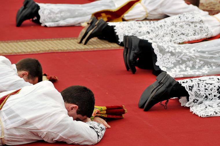 New priests prostrate themselves during the ordination Mass of the Society of St. Pius X in Écône, Switzerland, on June 29, 2009.