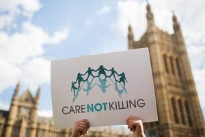 Campaigners against assisted dying gather outside the Houses of Parliament ahead of a House of Commons vote that rejected the legislation on Sept. 11, 2015, in London. 