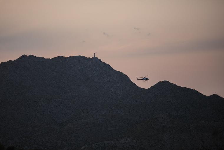 A U.S. Customs and Border Protection Helicopter is pictured patrolling the border at Mount Cristo Rey in Sunland Park, New Mexico, on July 22, 2021, with a statue of Christ just visible atop the mountain. The Diocese of Las Cruces is working to halt the federal government’s seizure of land at the base of the mountain.