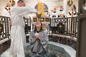 A baptism during the Rite of Christian Initiation at St. Mary’s Catholic Center in College Station, Texas.