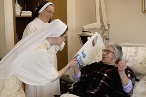 Dominican Sisters of Hawthorne spend time with a resident at Rosary Hill Home in Hawthorne, New York. 