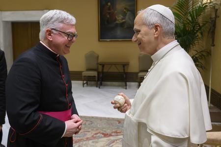 Msgr. Stuart Swetland presents a signed vintage Chicago White Sox baseball to Pope Leo during a June 3, 2026, private audience with Leo at the Vatican as part of a small delegation from the Association of Catholic Colleges and Universities.
