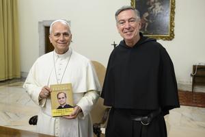 Father Joseph Farrell, prior general of the Order of St. Augustine, presents Pope Leo XIV with a newly published anthology of his pre-papal writings, at the Vatican on May 4, 2026. 