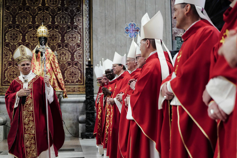 Pope Leo XIV walks by a group of archbishops during a Mass in St. Peter's Basilica for the blessing and imposition of the pallium on new metropolitan archbishops on June 29, 2025.