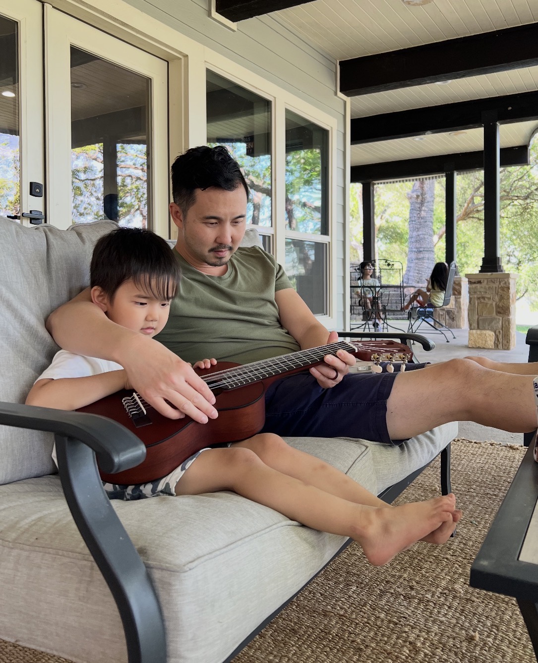 Paul J. Kim teaches his son Micah how to play the guitar. The grieving Catholic father and speaker now says "Micah is teaching him."