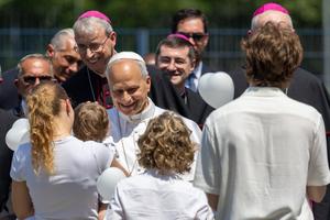 Pope Leo greets a young family during his pastoral day trip to Pavia, Italy, on June 20, 2026.