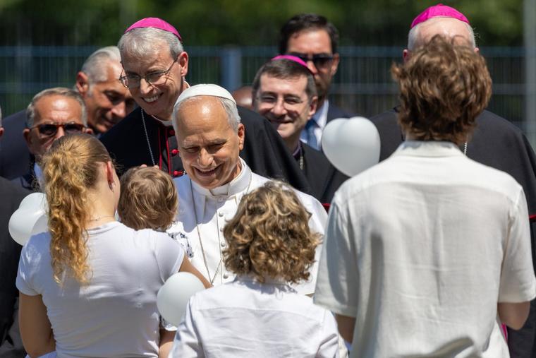 Pope Leo greets a young family during his pastoral day trip to Pavia, Italy, on June 20, 2026.