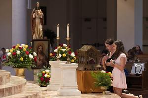 Diane Lauren and her daughter, Bray, 14, venerate the major relics of St. Margaret Mary Alacoque at the Basilica of the National Shrine of Mary, Queen of the Universe, in Orlando, Florida, on June 12, 2026.