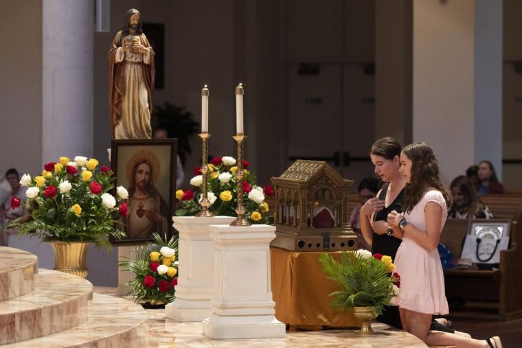Diane Lauren and her daughter, Bray, 14, venerate the major relics of St. Margaret Mary Alacoque at the Basilica of the National Shrine of Mary, Queen of the Universe, in Orlando, Florida, on June 12, 2026.