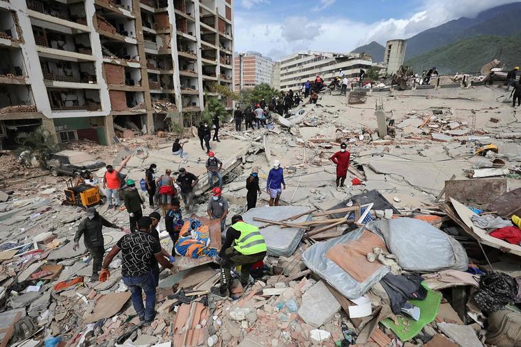 Rescuers carry the body of a victim at a collapsed building following a magnitude-7.2 earthquake that struck Venezuela and other regions in the Caribbean, on June 28, 2026, in Caraballeda, La Guaira, Venezuela.