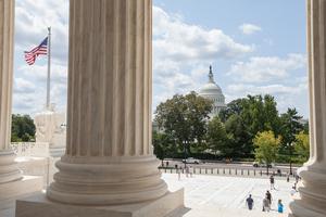 U.S. Capitol viewed through the columns of the U.S. Supreme Court in Washington, D.C.
