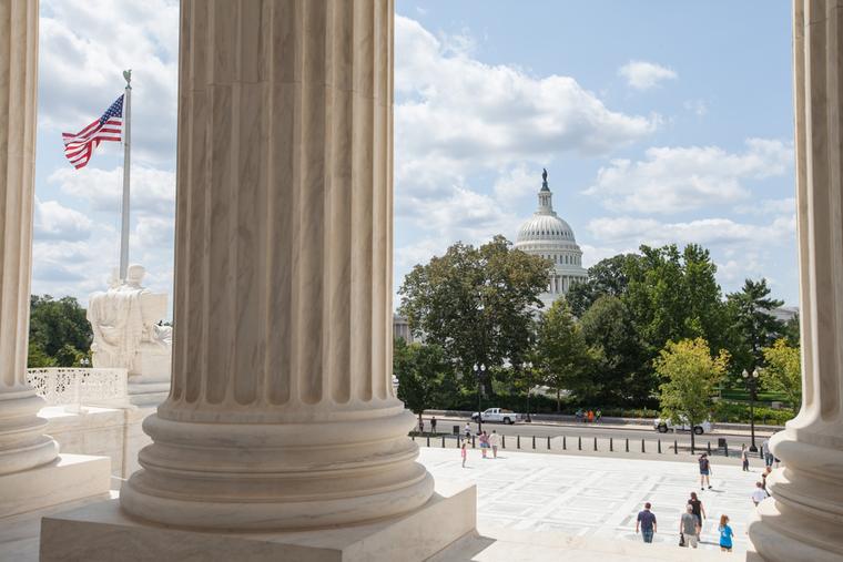 U.S. Capitol viewed through the columns of the U.S. Supreme Court in Washington, D.C.