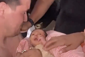 18-day-old Juan David reunited with his father after surviving a harrowing 32-hours with his mother under pounds of rubble following the devastating earthquake in Venezuela.