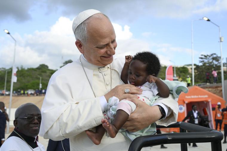 Pope Leo XIV greets a baby during his visit to the Marian shrine of Mama Muxima in Kimbaxe, Angola, on April 19, 2026.