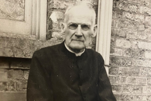 Congregation of Holy Cross Brother Columba O’Neill is seen at the back of the Holy Cross community house, c. 1923.