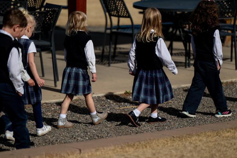 Students walk together at St. Mary Catholic Virtue Preschool in Littleton, Colorado. 