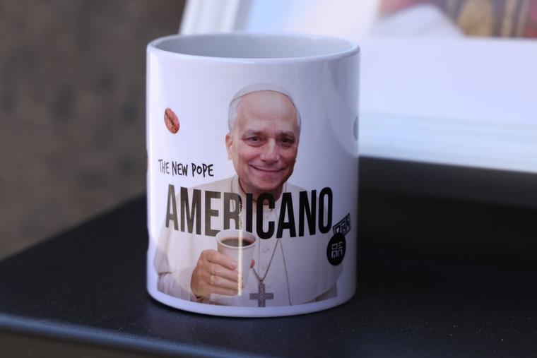 A portrait of Pope Leo XIV adorns a coffee cup with the word ‘Americano,’ which refers both to Pope Leo XIV’s nationality and a popular Italian coffee type, outside a coffee shop in Rome on May 17, 2025. 