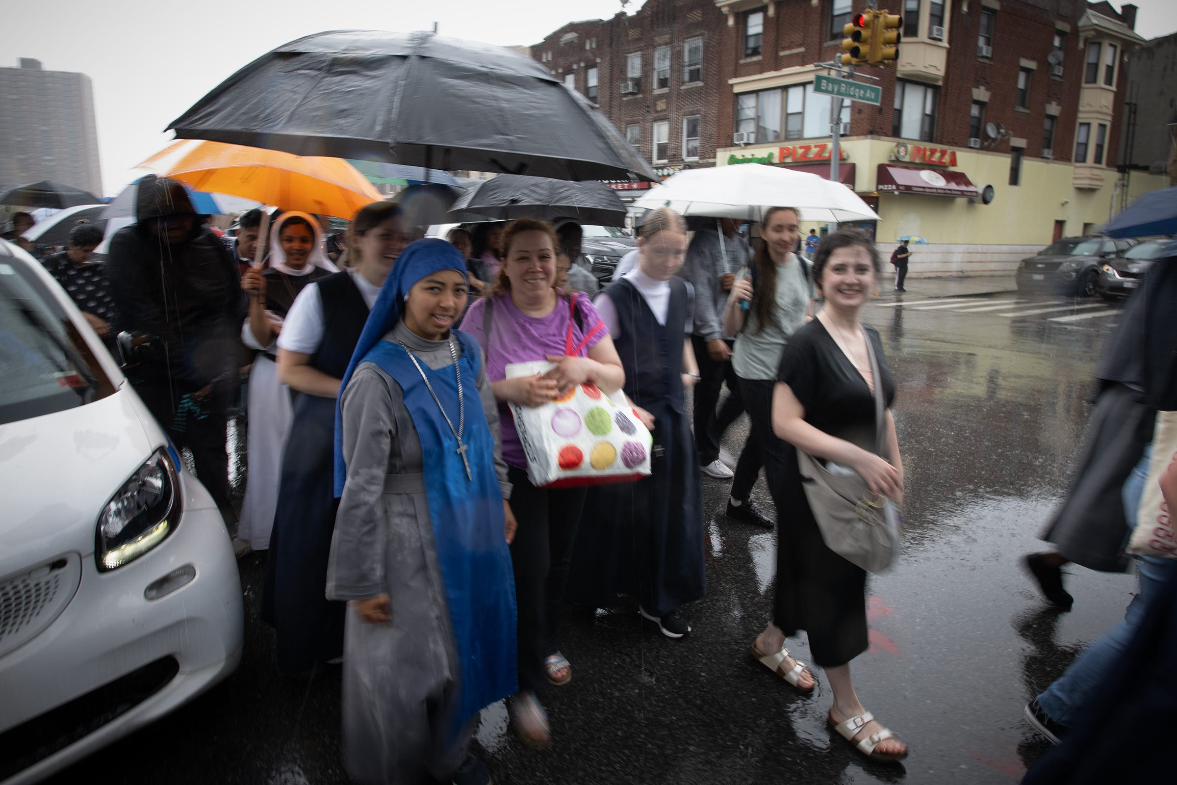 Pilgrims walk happily in the rain.