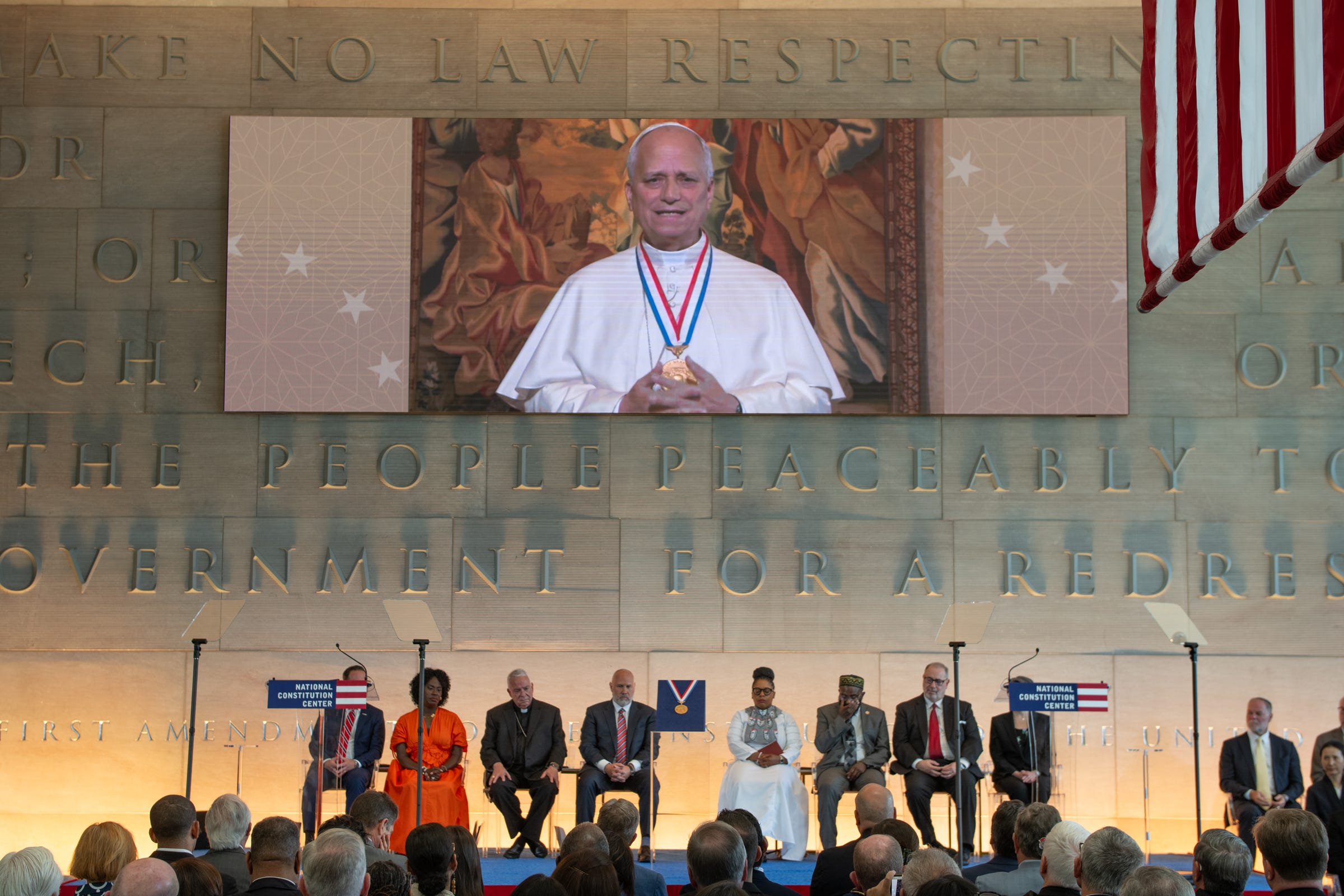 As Pope Leo XIV accepted the Liberty Medal, the carved language of law, liberty, peace, and ordered government surrounded him. A reminder that the American experiment is at its best when freedom is not merely protected, but directed toward the dignity of the human person and the glory of God.