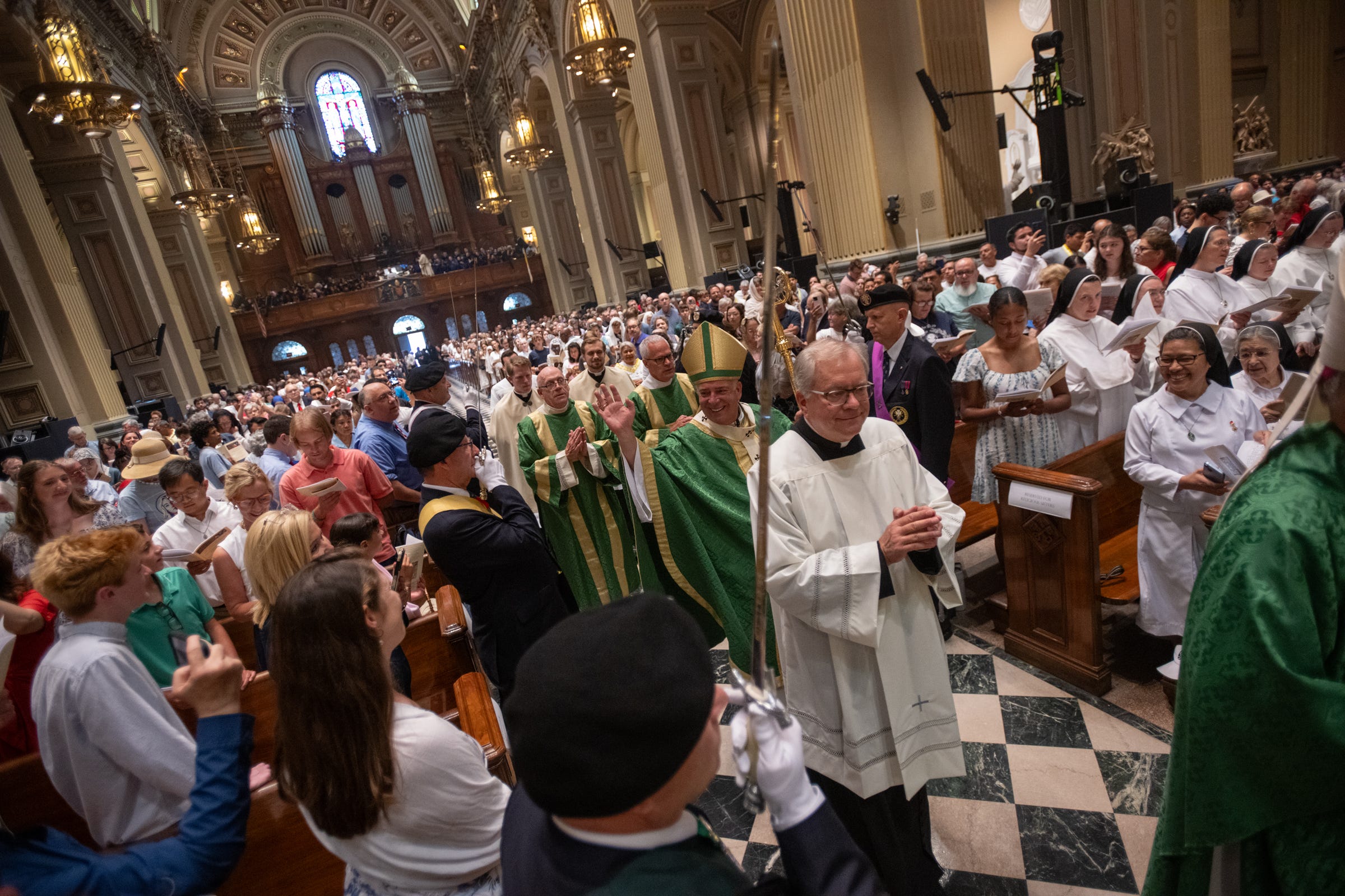 At the closing Mass of the 3rd National Eucharistic Pilgrimage, the entrance procession moved through the packed cathedral, shepherds and faithful pressed together beneath stone, stained glass, and song.