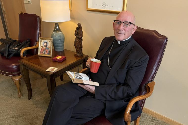 Bishop Edward Rice enjoys his coffee. 