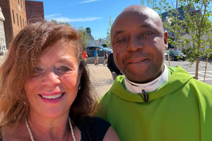L to R: Janine Boucher, a parishioner, smiles for a photo with the late Father Benjamin Madu, who died July 2.  