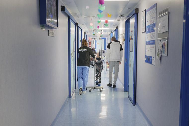 A patient in rehabilitation walks down the hall of Bambino Gesù Pediatric Hospital. 