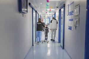 A patient in rehabilitation walks down the hall of Bambino Gesù Pediatric Hospital. 