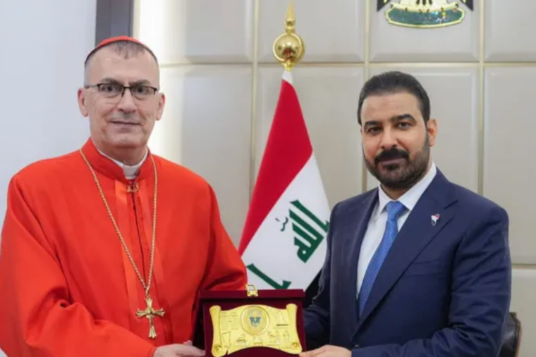 Iraqi Prime Minister Ali al Zaidi, right, receives Chaldean Patriarch Mar Paul III Nona. 