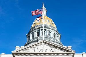 The Colorado State Capitol, topped by its iconic gold dome, stands in downtown Denver.