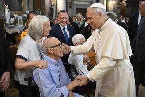 Pope Leo speaks with a couple at the Parish Church of St. Anne in the Vatican on Sept. 21, 2025. 