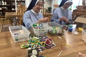 Sister Mary Alma (on the left) and Sister Mary Agnes of the School Sisters of Christ the King in Lincoln, Nebraska, enjoy the process of beading, comprised of various stages.