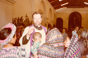Father Stanley Rother blesses a baby in Guatemala.