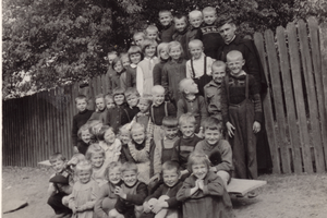 Father Roman Kotlarz is seen in a photo with young parishioners.