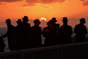Orthodox Jewish men perform the “Tashlich” ritual, during which “sins are cast into the water to the fish,” in Israel's coastal city of Netanya, on Sept. 30, 2025, ahead of the Day of Atonement, or Yom Kippur, the most important day in the Jewish religious calendar.